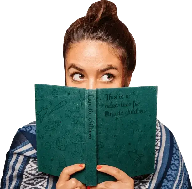 Reader holding a green book just below her eyes, curious and engaged