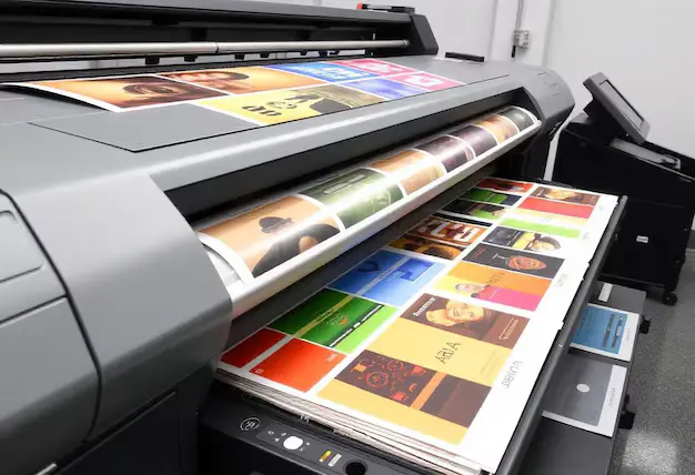 Wide-format printer producing rows of colorful book covers